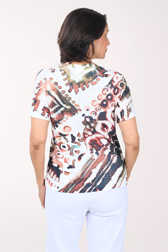 Woman wearing a colorful patterned shirt on a white background