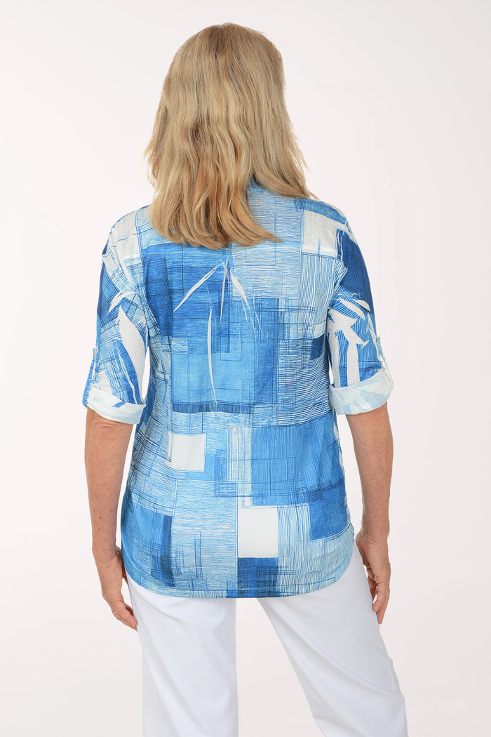 Woman wearing a blue plaid shirt with a white background