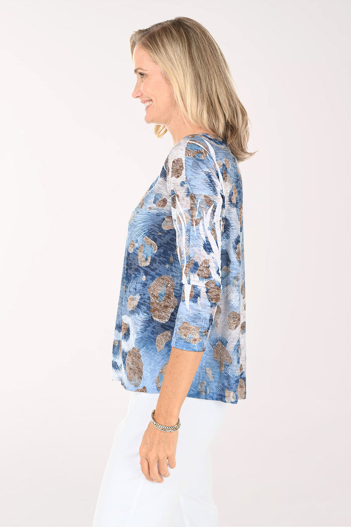 Woman wearing a blue floral blouse on a white background