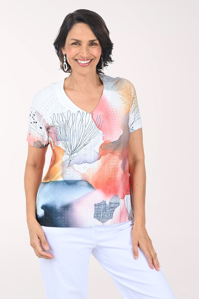 Woman wearing a colorful top with a white background