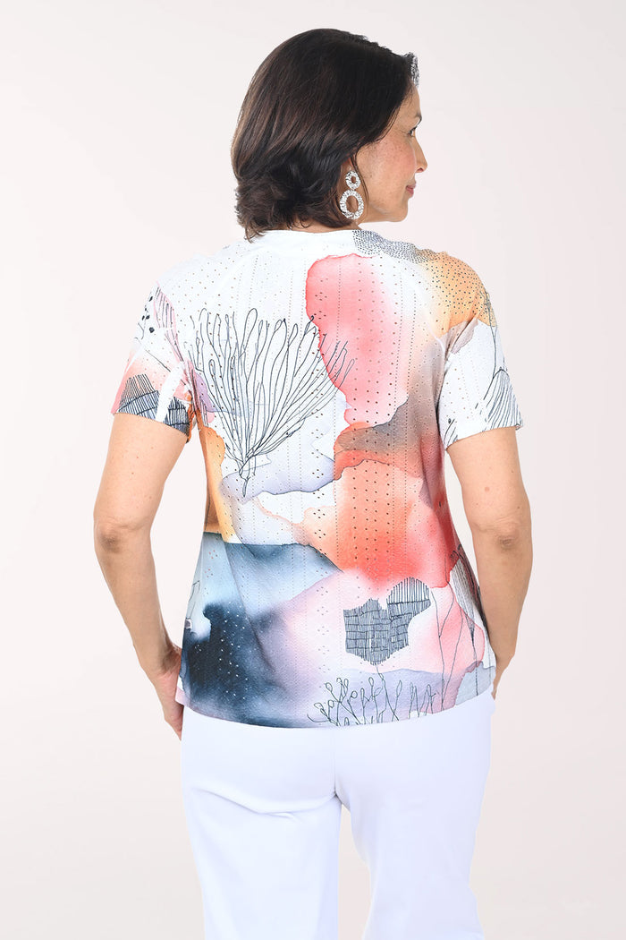 Woman wearing a colorful top with a white background