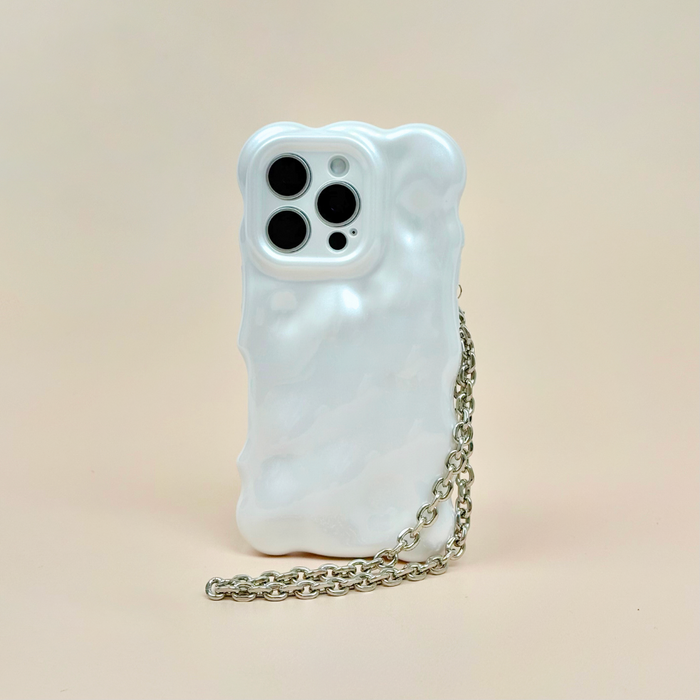 Silver chain phone strap from Coconut Lane on a white wavy case, set against a light beige background.