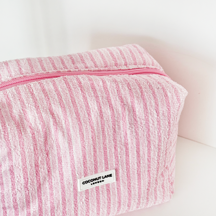 Makeup bag and scrunchie set with pastel powder stripes pattern; towel-like textured fabric.