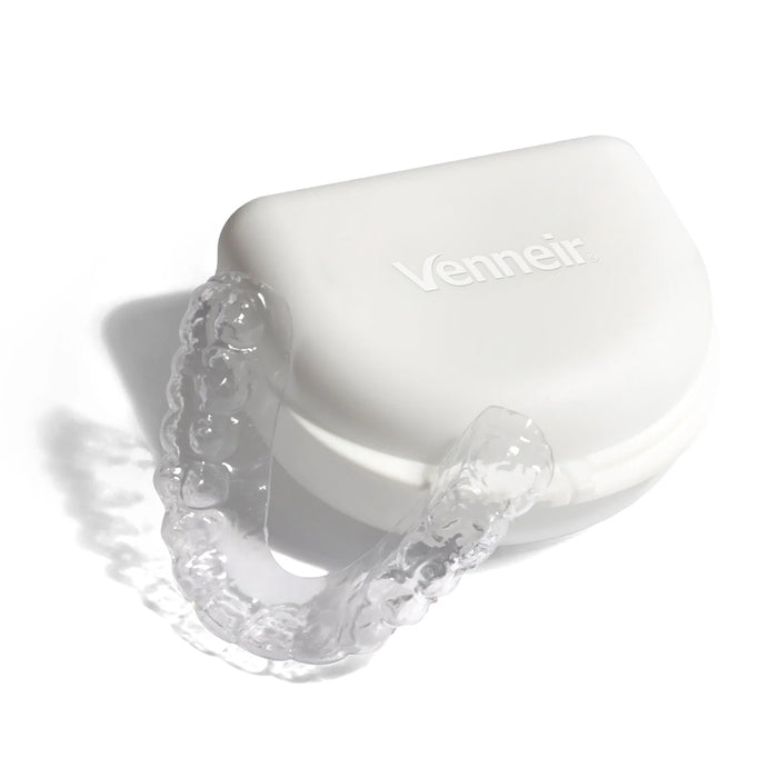 Clear lower teeth whitening tray with dosing dots on white background