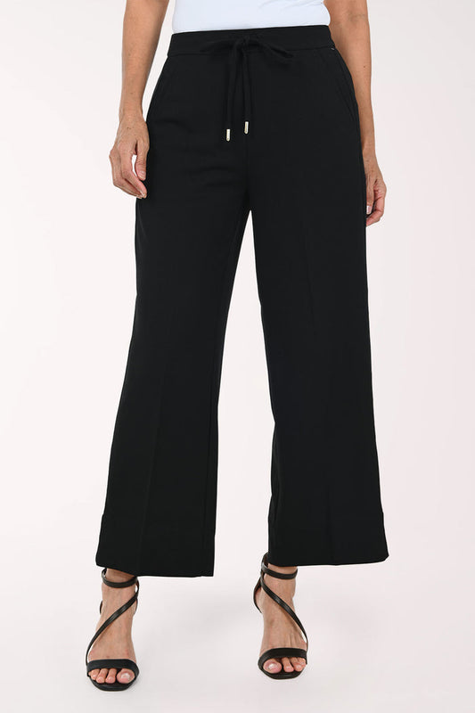Black wide-leg cropped pants with a drawstring waist, shown on a model wearing black strappy heels against a plain light background.