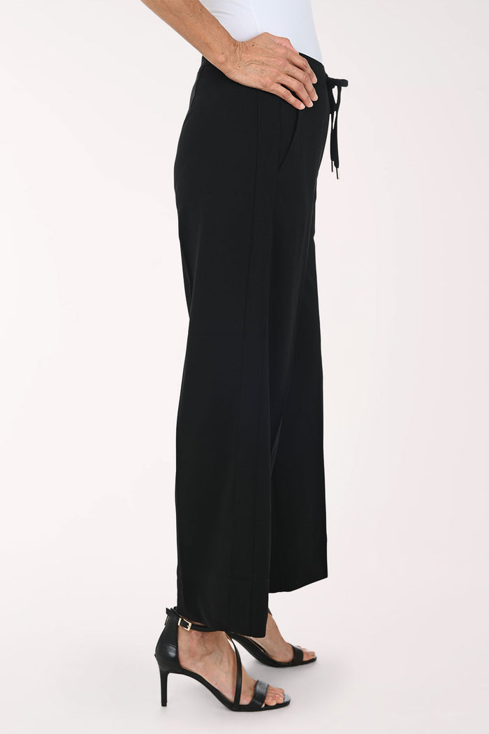 Black wide-leg cropped pants with a drawstring waist, shown on a model wearing black strappy heels against a plain light background.