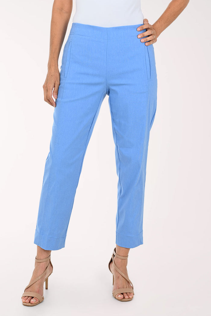 A model wearing light blue cropped trousers with side pockets, paired with beige strappy high-heeled sandals against a plain white studio background.