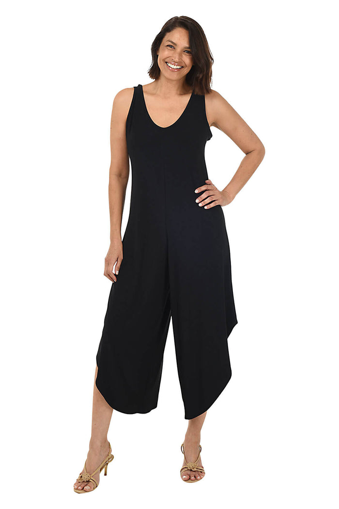 Woman wearing a black sleeveless jumpsuit on a white background