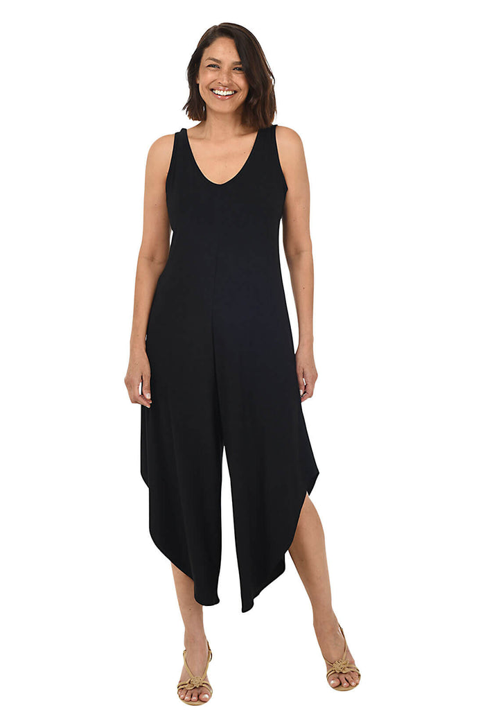 Woman wearing a black sleeveless jumpsuit on a white background