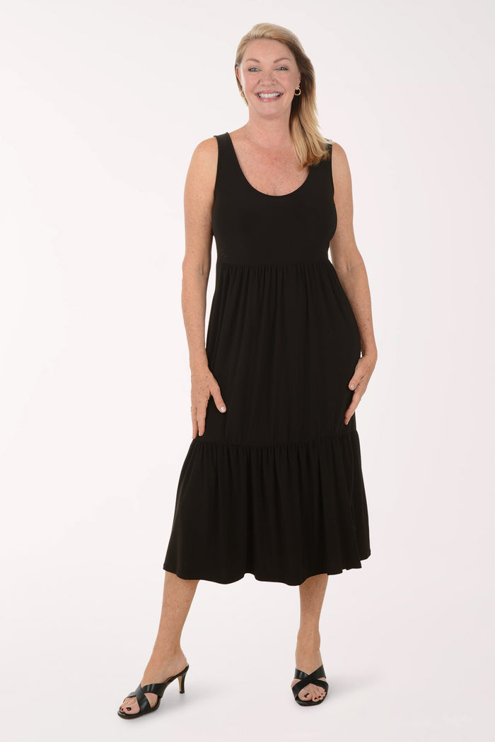 Woman wearing a black sleeveless dress on a white background