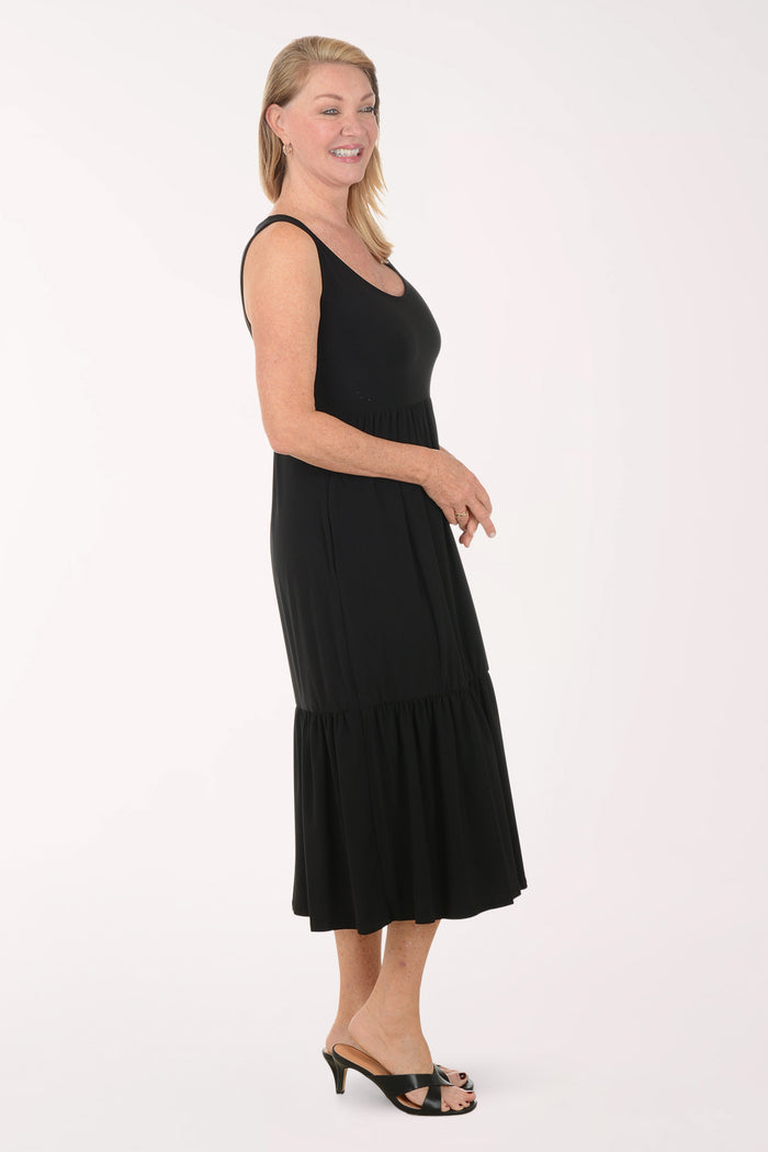 Woman wearing a black sleeveless dress on a white background