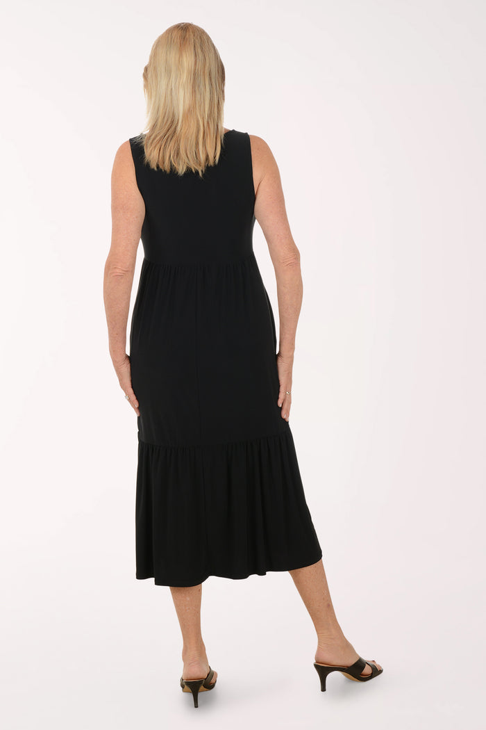 Woman wearing a black sleeveless dress on a white background