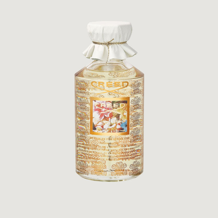Creed Spring Flower 490ml flacon with gold floral label and white leather cap - Front View | Creed Fragrances