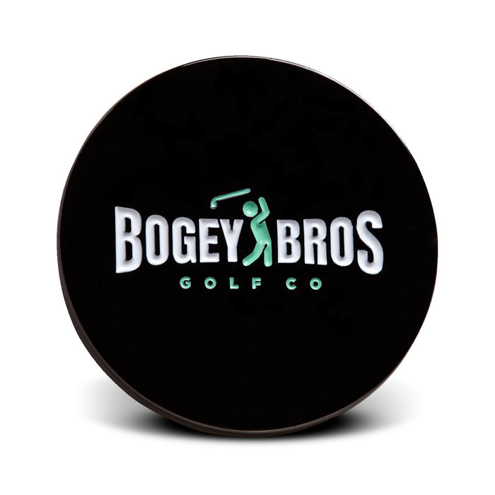 The Big Coin - Ball Marker is a round black marker with "Bogey Bros Golf Co" in white and a green golfer silhouette forming part of the "E" in BROS. It is shown upright against a white background.