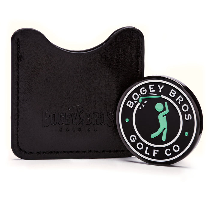 The Big Coin - Ball Marker features a double-faced design with a green golfer icon, white "Bogey Bros Golf Co" text, and black with green and white accents. It comes in a black leather case embossed with “Bogey Bros Golf Co.”.