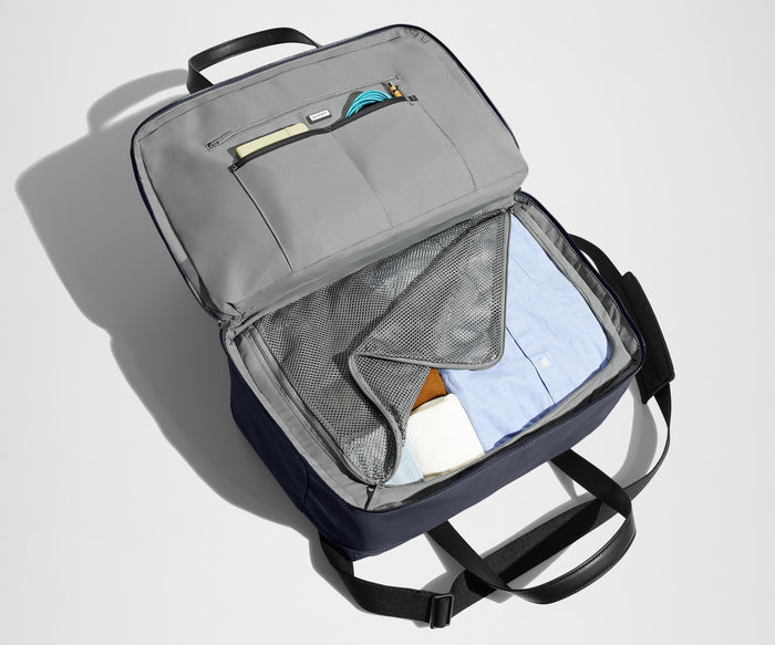 Main interior packed with clothing. Slip pockets packed with a notebook and charging cords
// The Overnight Bag features a detachable padded shoulder strap.