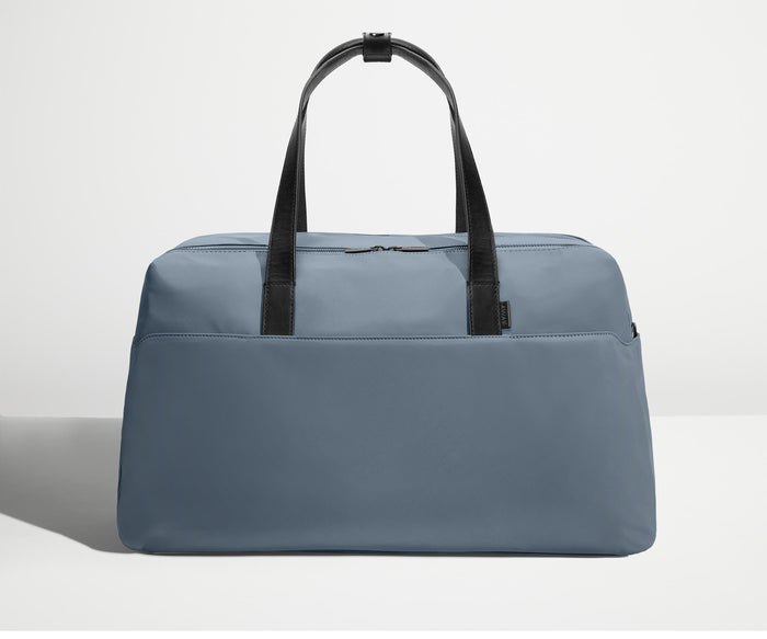 Front view of Away's Weekender duffle in Coast Blue with handles up