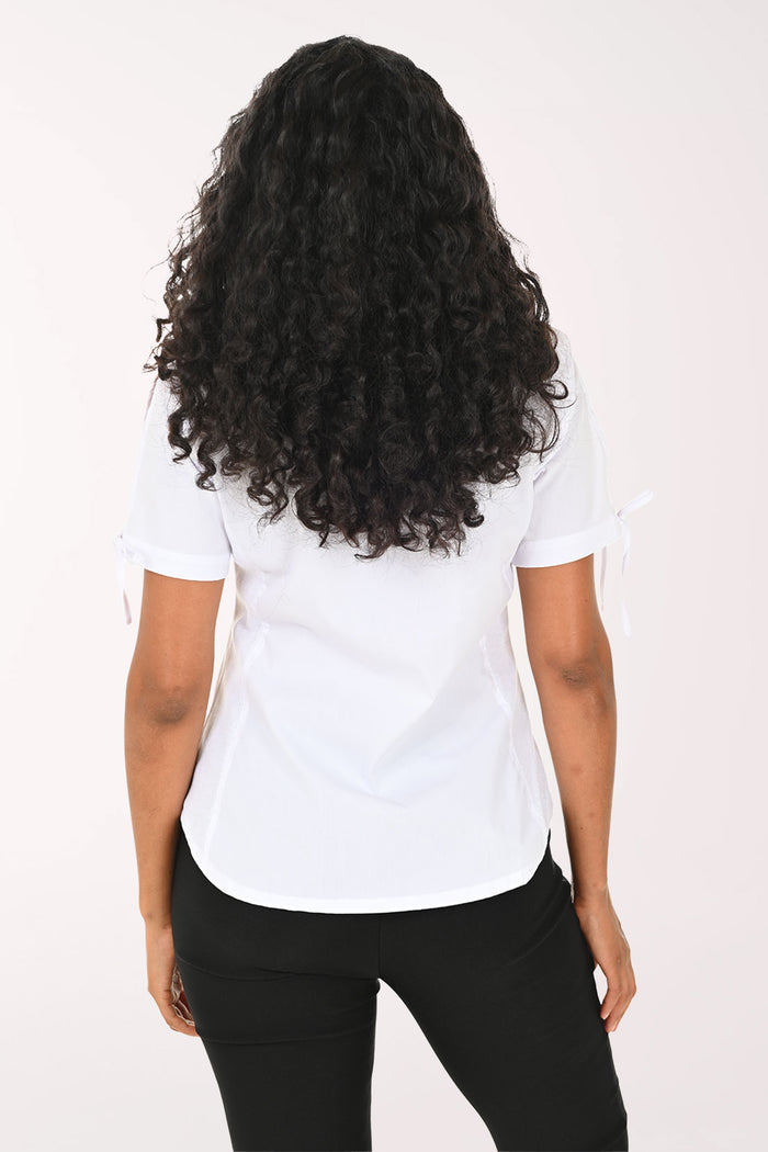 Woman wearing a white short-sleeve shirt and black pants on a white background
