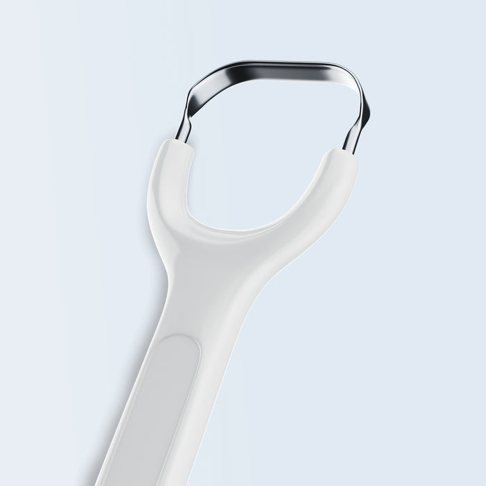 Stainless steel tongue scraper with white handle on white background