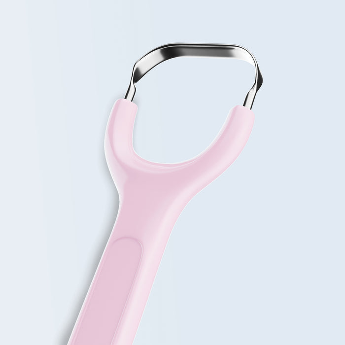 Stainless steel tongue scraper with pink handle on white background