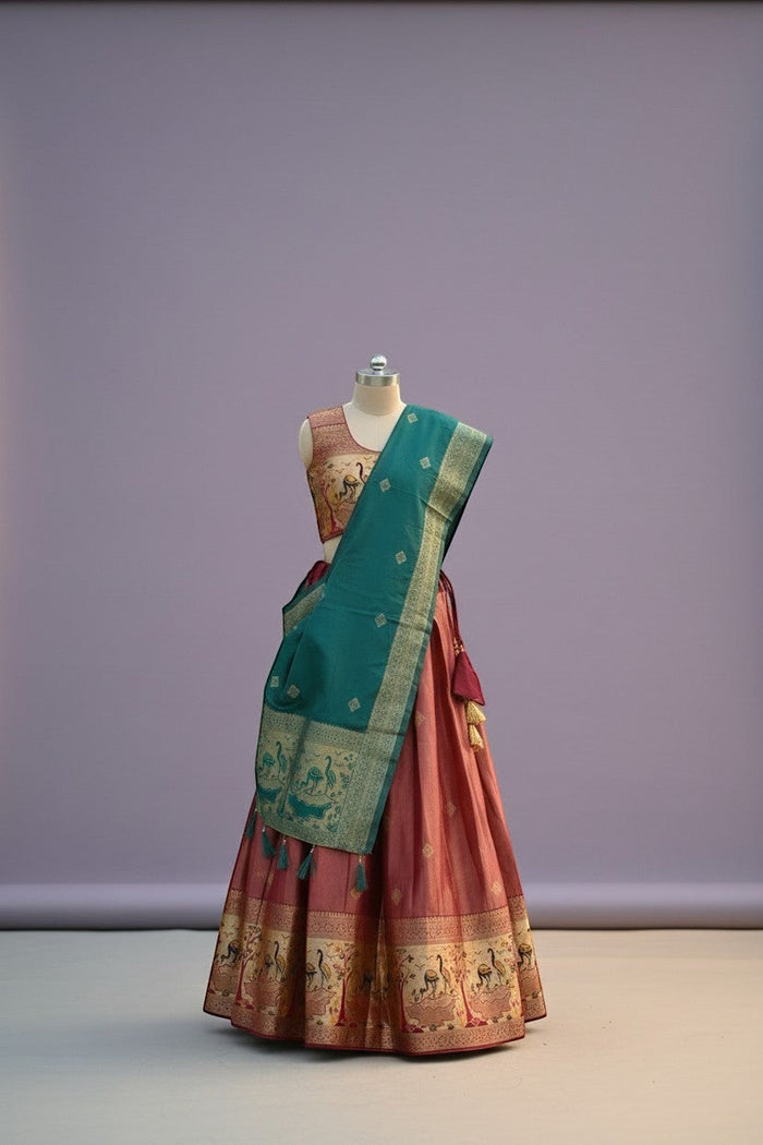 House Of Indian Wedding Attire pink silk lehenga choli with teal dupatta featuring peacock motifs and tassels.