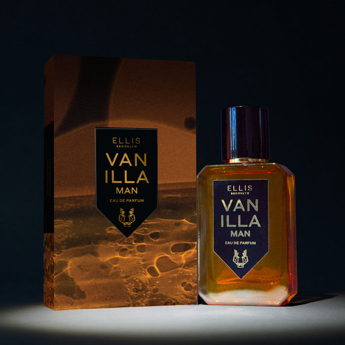 Vanillla Man 50ml Eau De Parfum next to Vanilla Man Eau De Parufm box in spotlight, on black background.