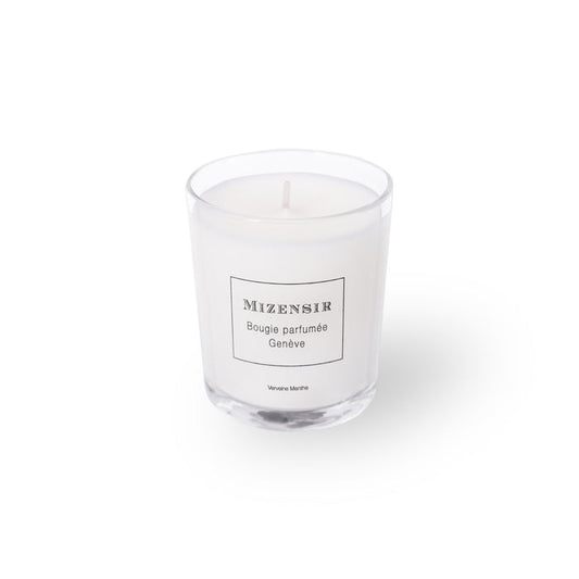 A white scented candle in a clear glass container with a label that reads "Mizensir Bougie Parfumee Geneve".