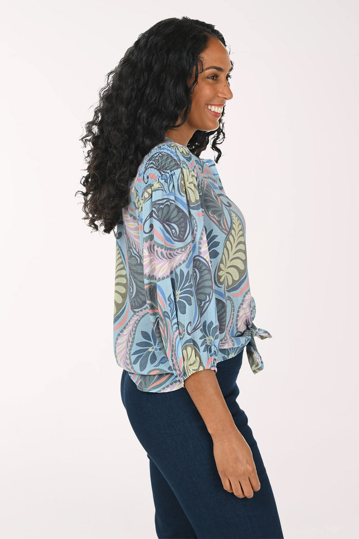 Woman wearing a patterned blouse with a white background