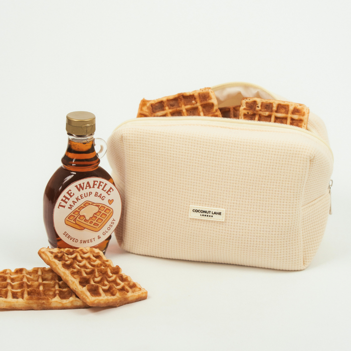 Cream Coconut Lane makeup bag with waffle design, shown with a syrup bottle inside and two waffles in front.