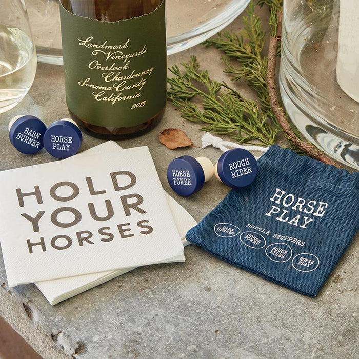 Chardonnay bottle with Horse Play bottle stoppers and napkins